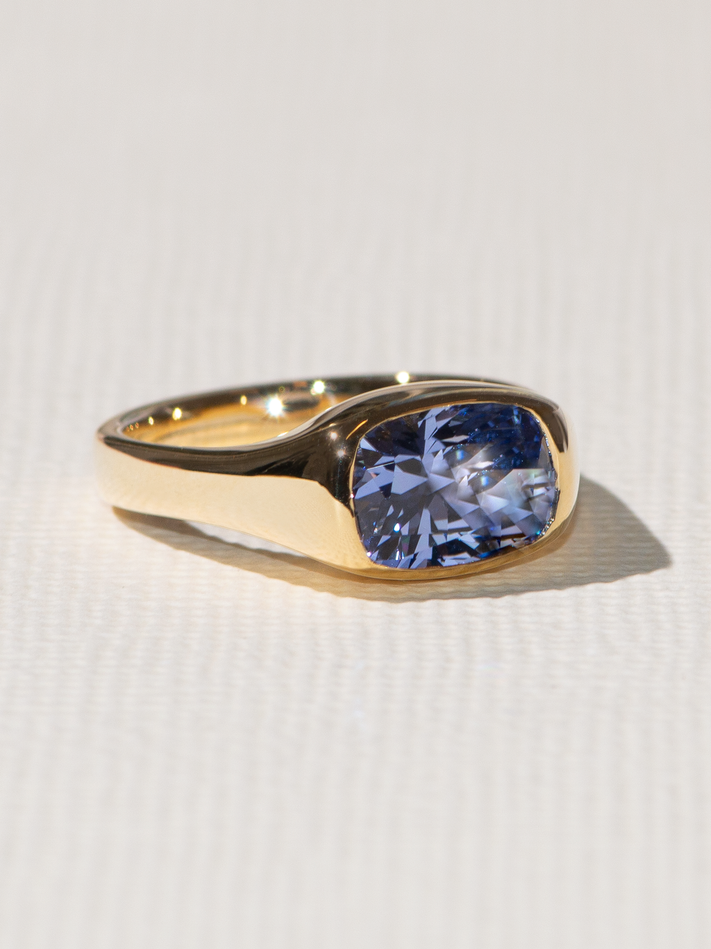 Bespoke signet style ring with a blue lab sapphire.