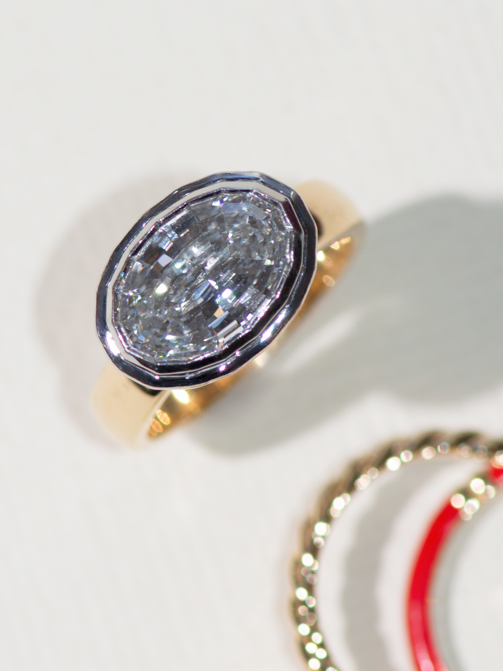 Oval shaped diamond with step cut internal facets rather than brilliant.