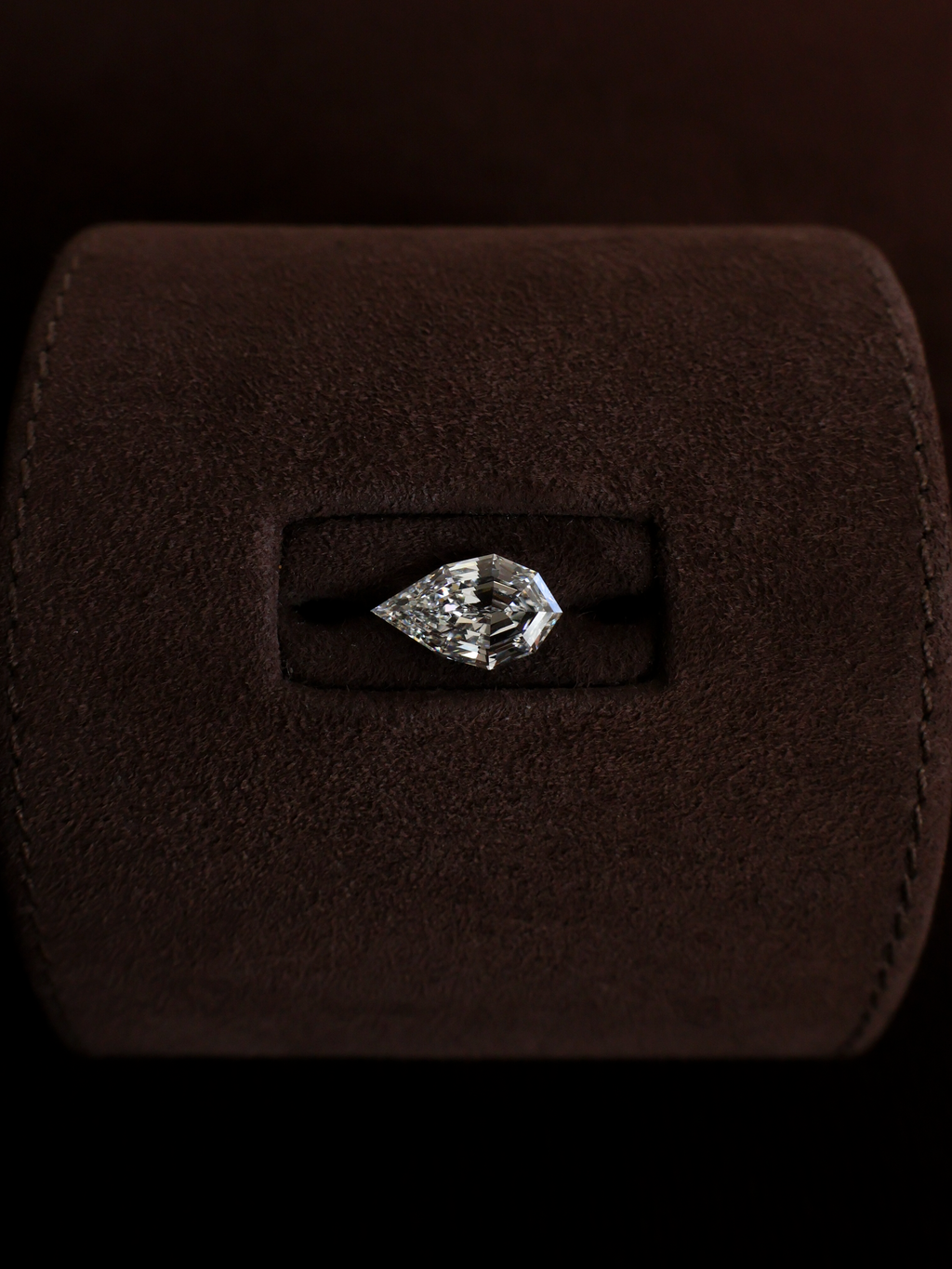 A pear shaped diamond but step cut internal facets instead of a classic brilliant cut.