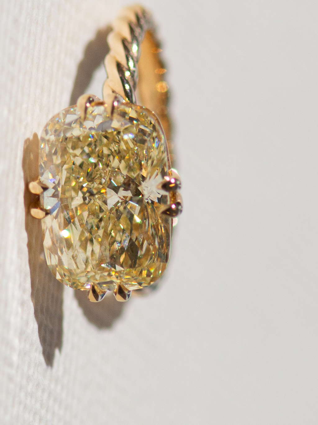 A bespoke solitare with yellow elongated cushion lab diamond.